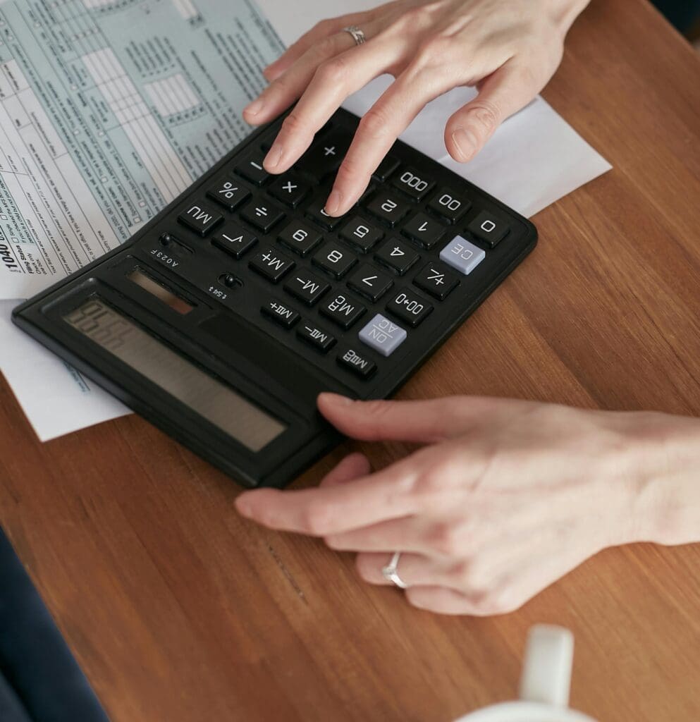 a business owner using a calculator for collecting invoices